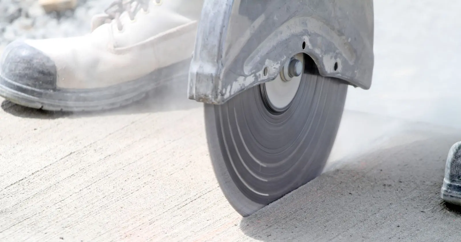Angle grinder cutting concrete with a diamond blade