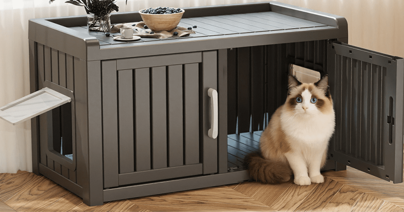 realistic home decor photograph of a bright, stylish pet-friendly home showing several smart litter box ideas to keep dogs out without stressing the cat. Include a top-entry litter box, an enclosed litter box cabinet, a baby gate with a small cat door, a wall-mounted litter box shelf, a microchip cat flap entry, and scent deterrent mats placed around one setup. Show a calm cat comfortably using or approaching the litter area while a curious dog stays outside the restricted spaces. Use warm neutral tones, soft natural light, light wood finishes, clean organized styling, subtle pet accessories, and a polished magazine-quality interior design look. No people, no clutter, no watermark.